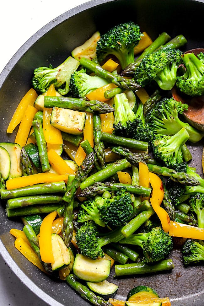broccoli, asparagus, yellow bell peppers, and zucchini sautéing in skillet to make pasta primavera.