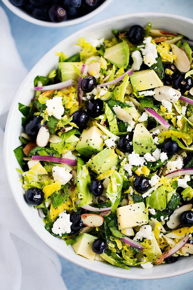 Shaved Brussels Sprouts Salad with Blueberries, Avocado, and Almonds.