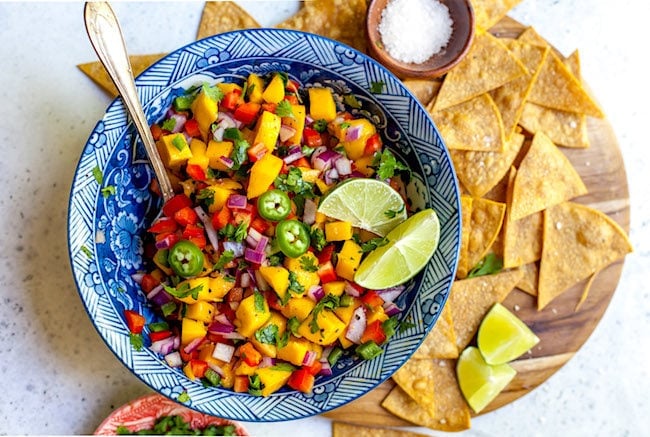Mango Salsa in bowl with tortilla chips.