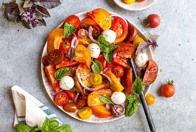 tomato salad with fresh mozzarella on plate.