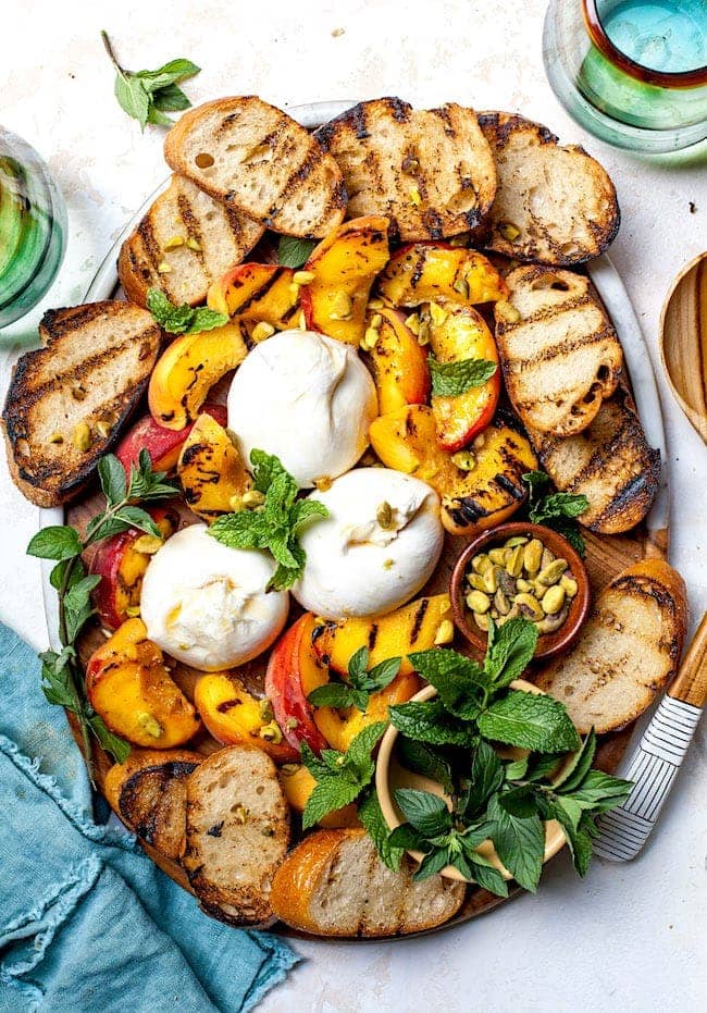 Grilled Peaches with Burrata, Honey, & Pistachios - Two Peas & Their Pod