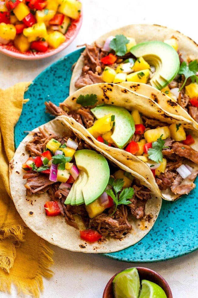 Carnitas served in tacos on plate.
