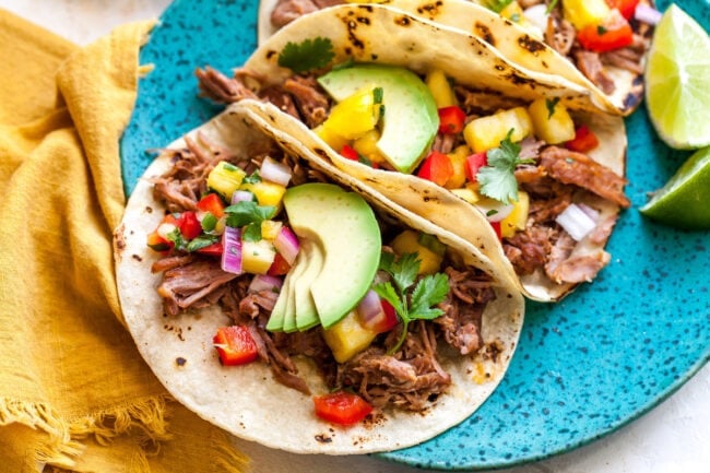 Crispy Carnitas in tacos with toppings.