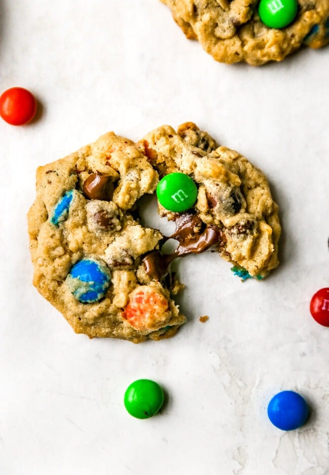 Monster cookie broken in half with melty chocolate and M&M's. 