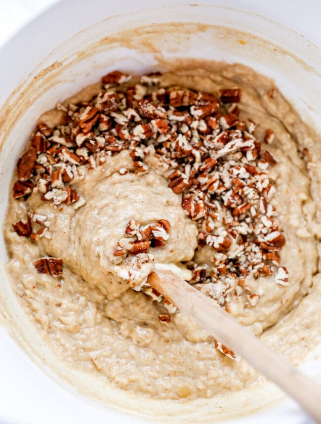 banana nut bread batter in bowl with spatula. 