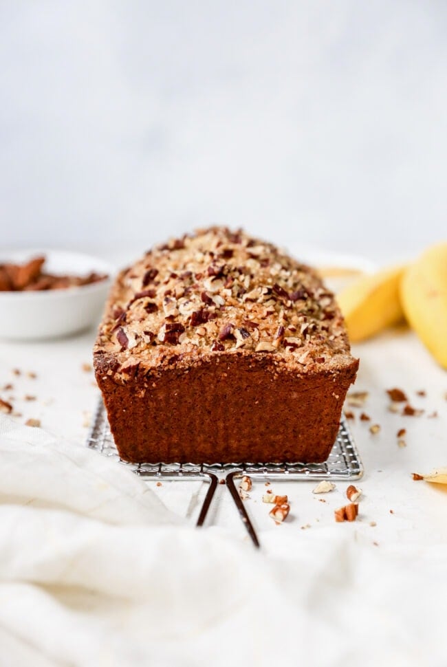 loaf of banana nut bread on cooling rack. 