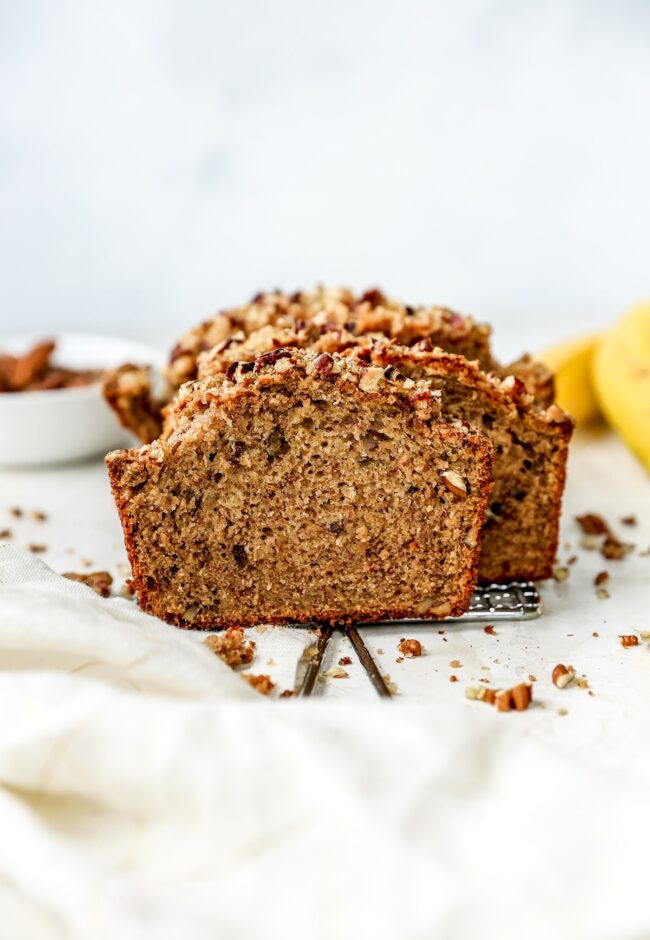 Banana Nut Bread cut in slices on cooling rack.