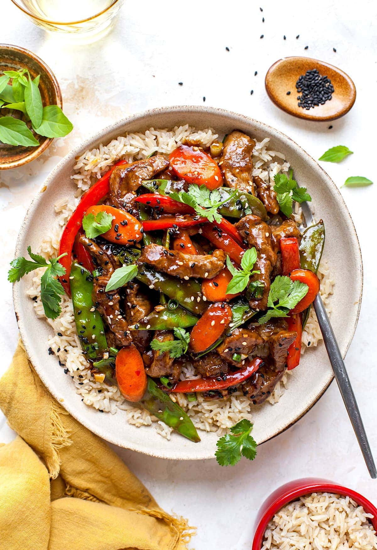 Beef Stir Fry in bowl with rice and fork. 