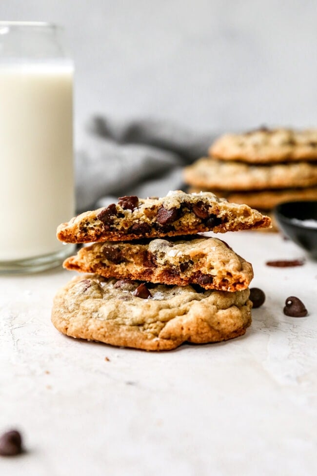 small stack of Doubletree Chocolate Chip Cookies with glass of milk. 