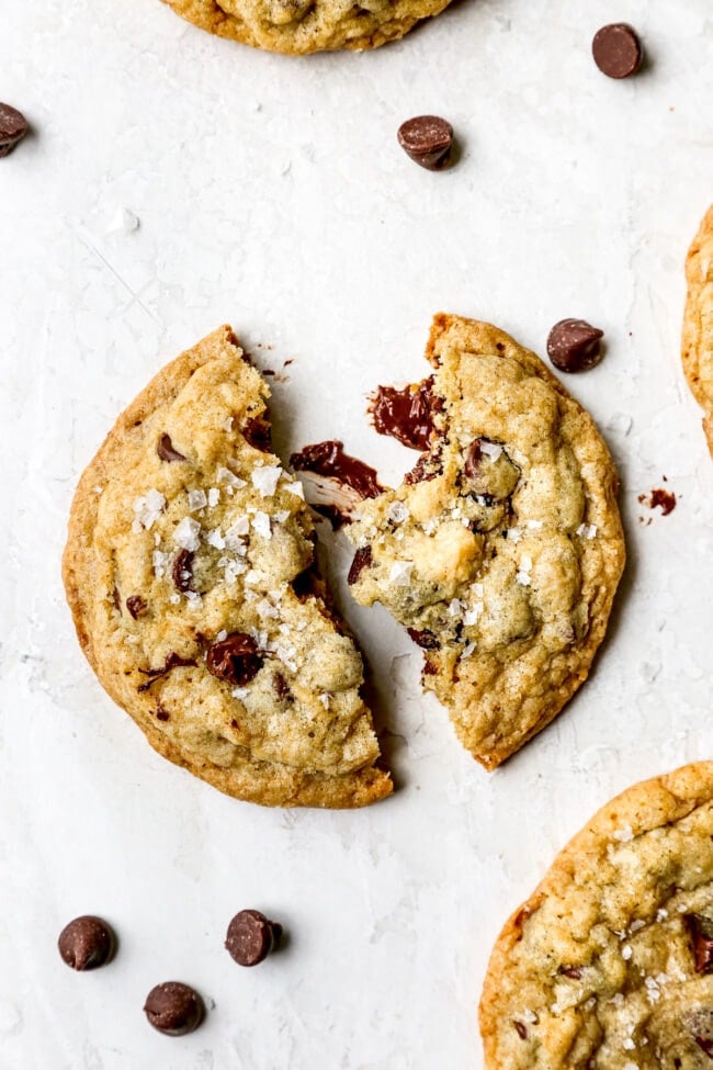 Doubletree Chocolate Chip Cookie broken in half with flaky sea salt on top.