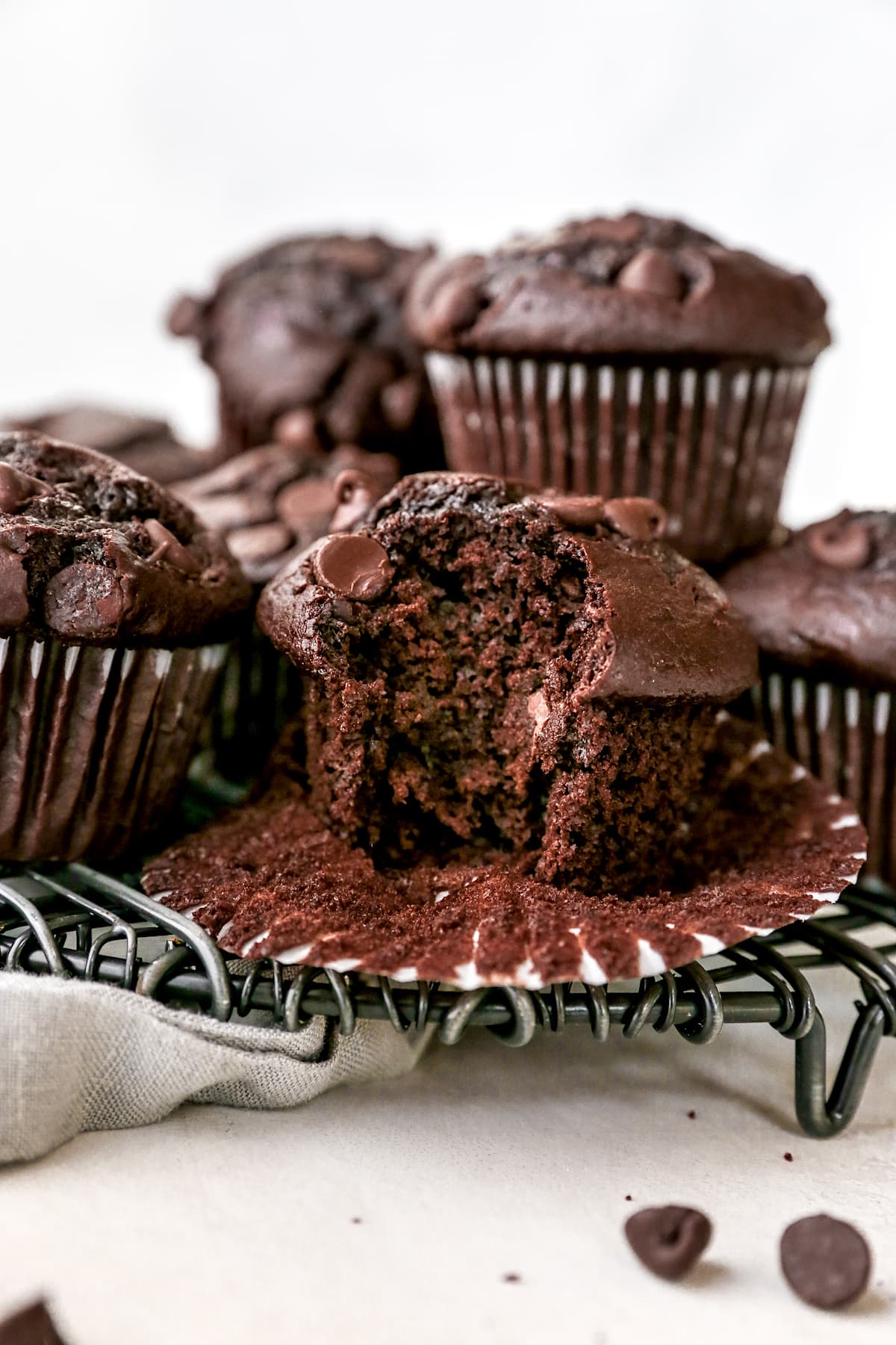 chocolate muffin unwrapped with bite taken out. 