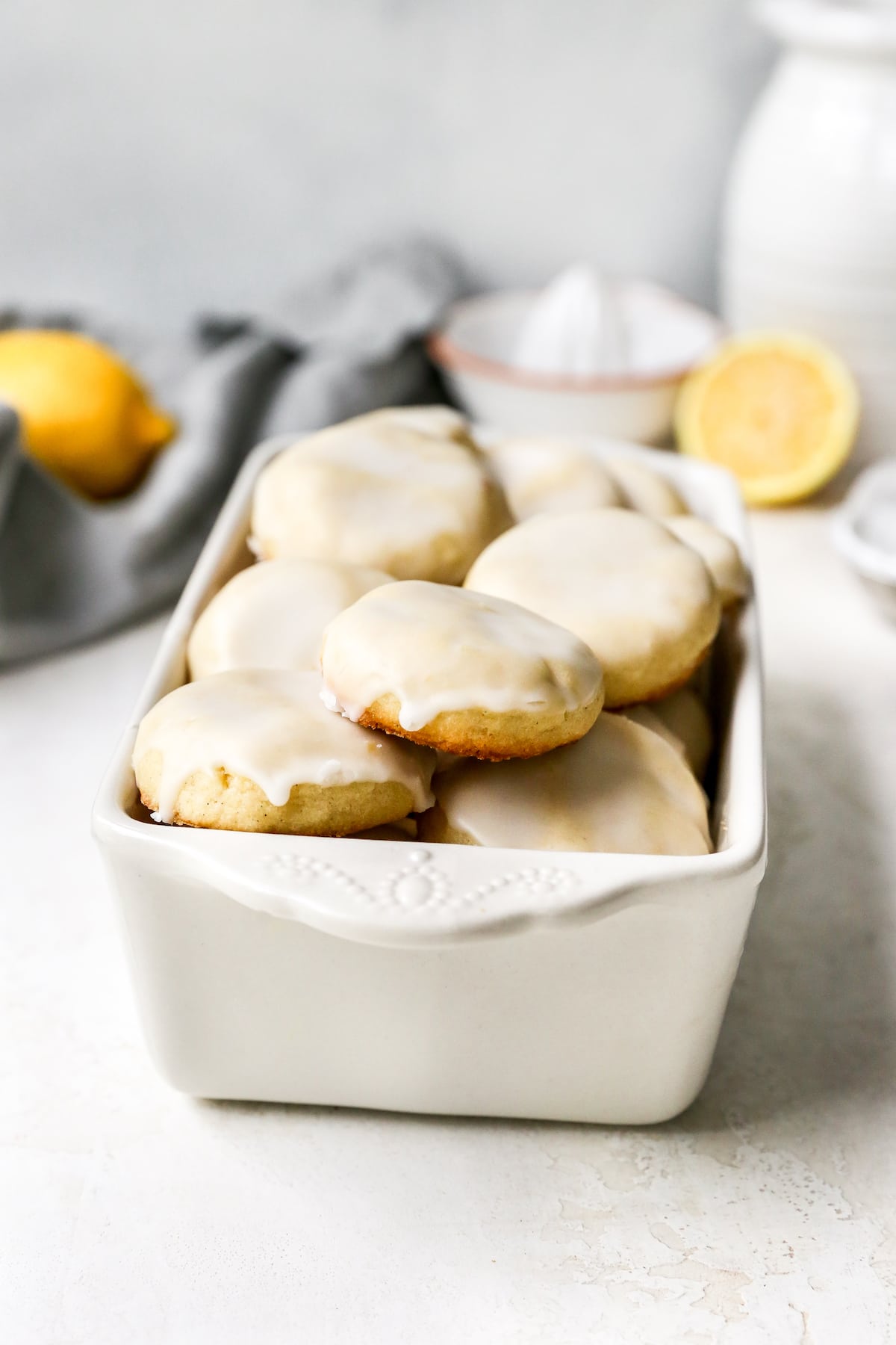 lemon cookies with lemon glaze in white loaf pan.