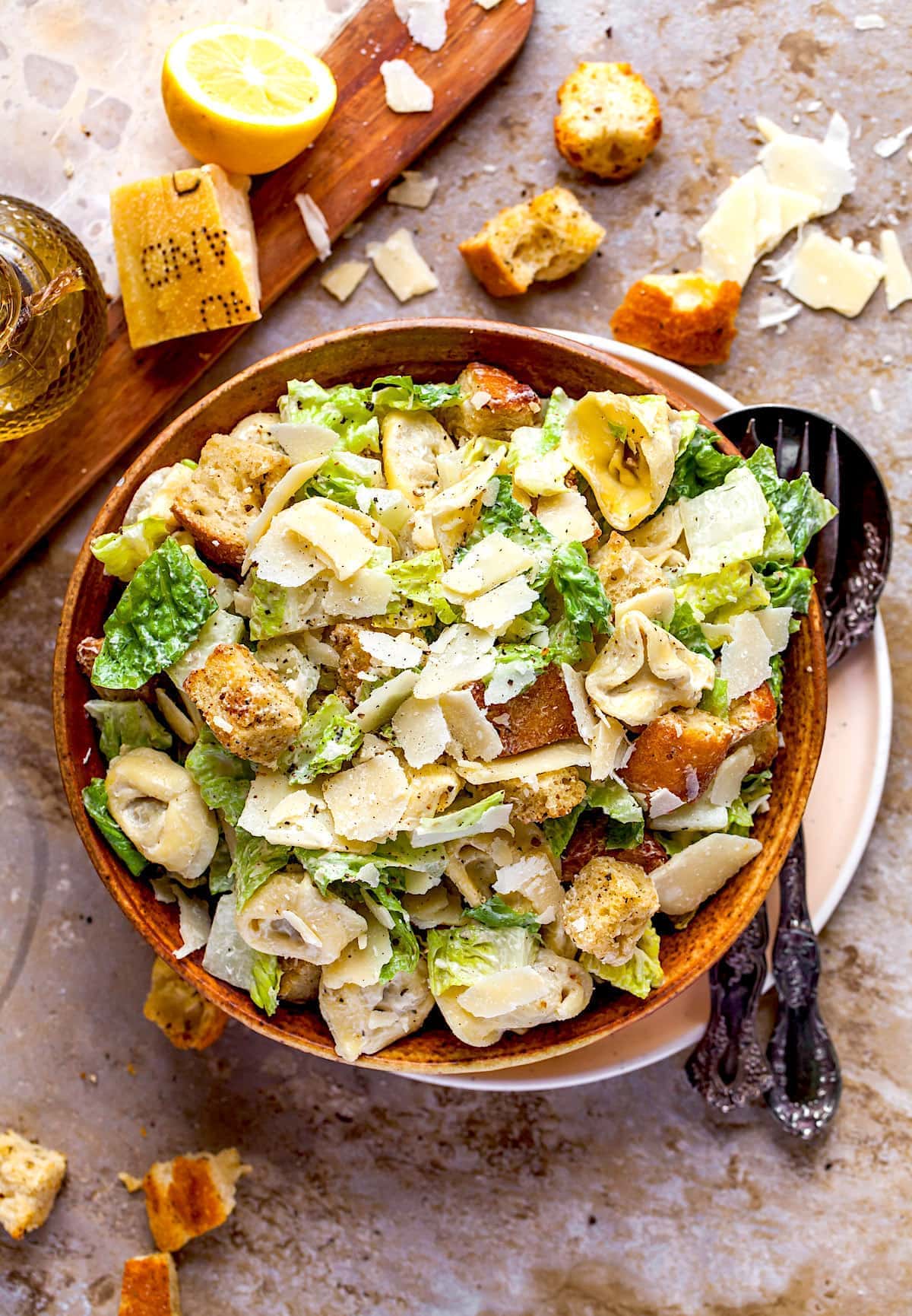 Tortellini Caesar Salad  in wood bowl with Parmesan cheese and homemade croutons. 