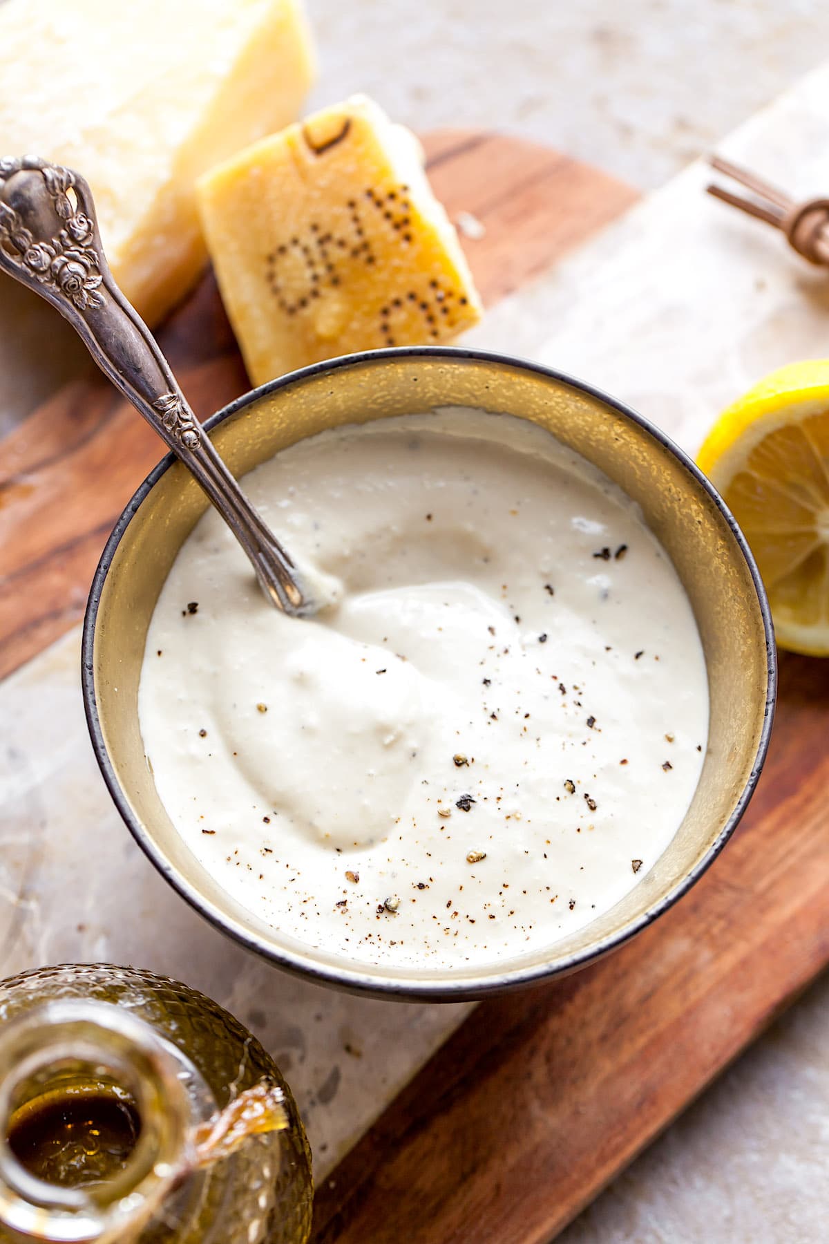 Caesar Salad Dressing in bowl with spoon. 