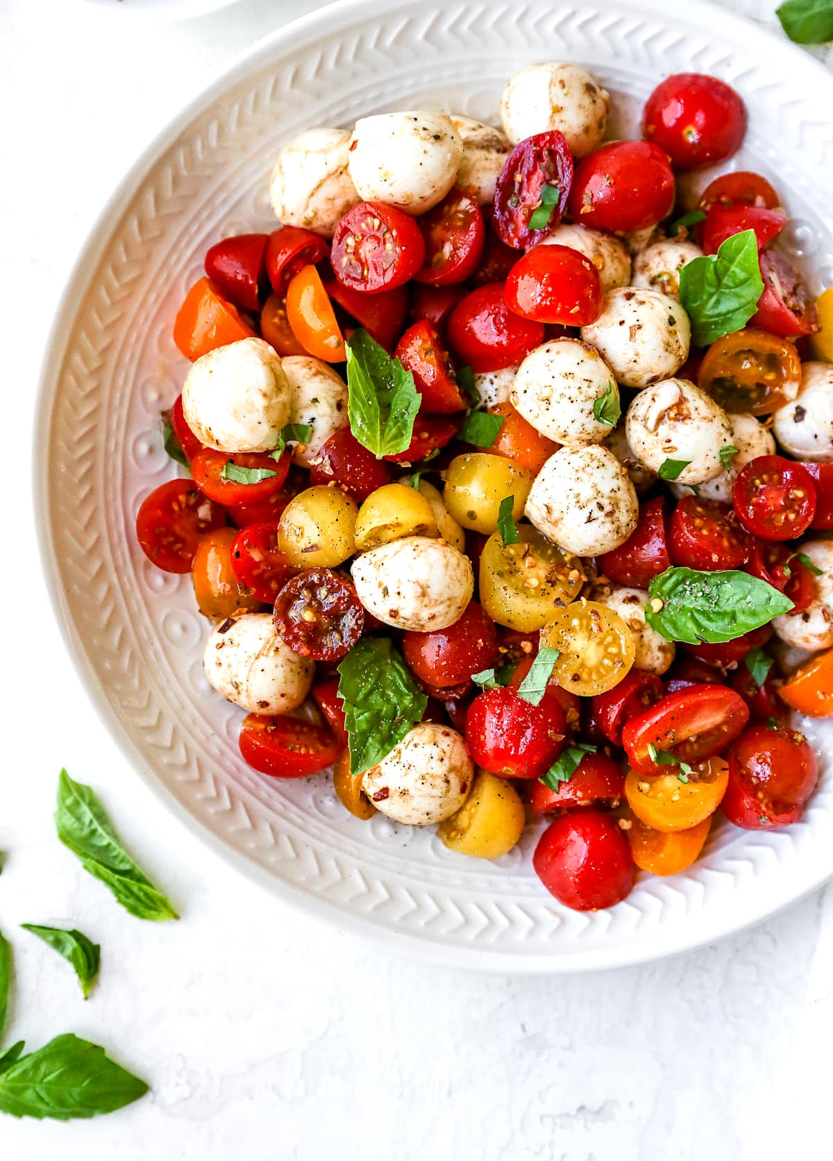 tomatoes, fresh mozzarella, and basil in bowl.