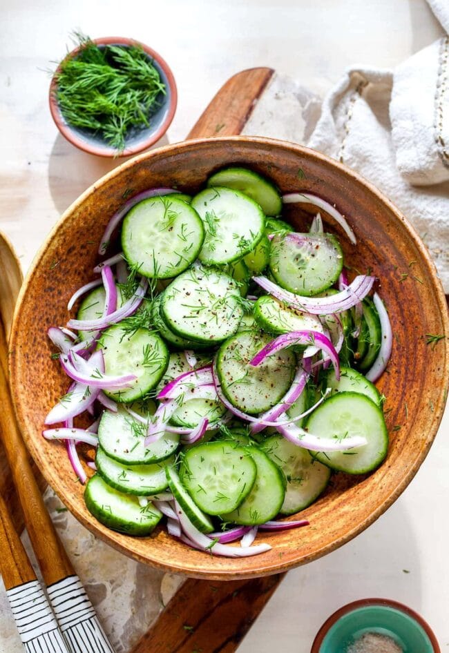 Cucumber Salad in bowl with red onion and dill