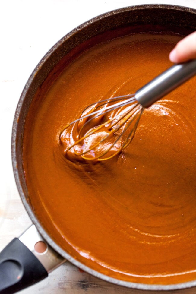 making enchilada sauce in pan with whisk 