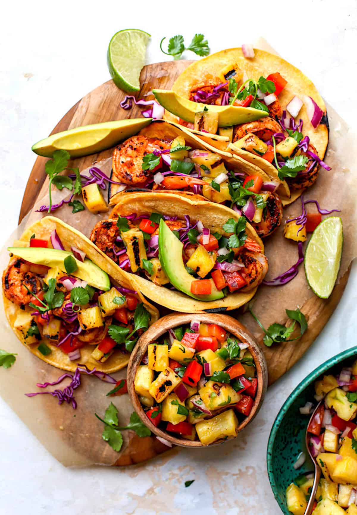 shrimp tacos with grilled pineapple salsa on wood board. 