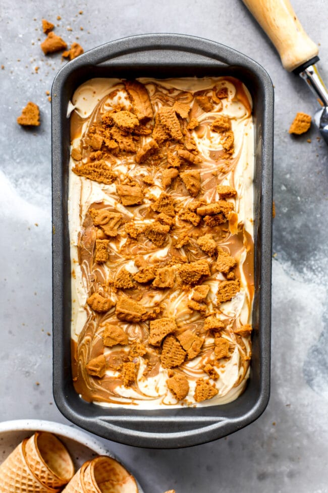 No Churn Biscoff Ice Cream in pan with crushed cookies on top