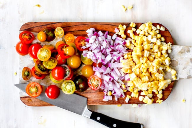 chopping ingredients for summer quinoa salad on cutting board