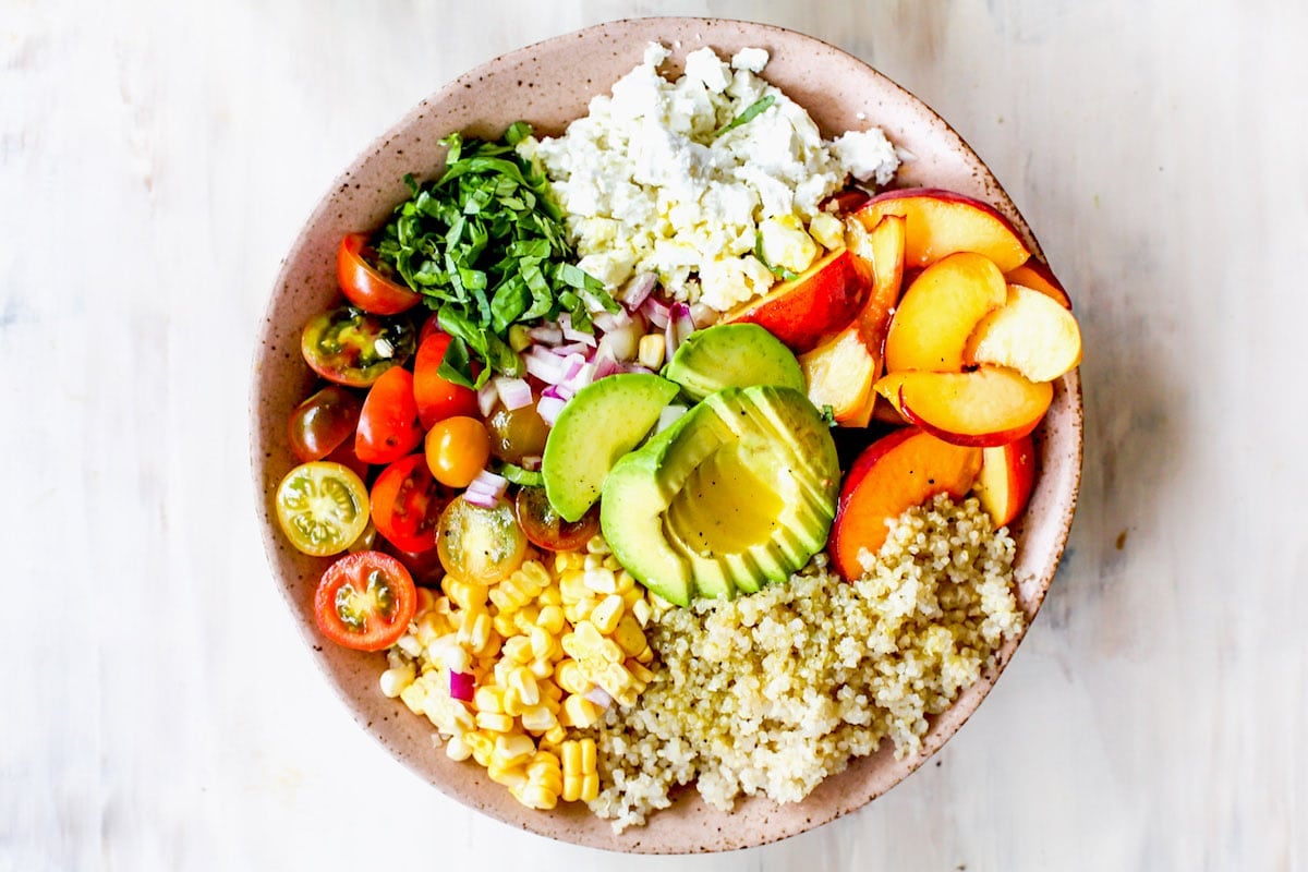 summer quinoa salad ingredients in serving bowl. 