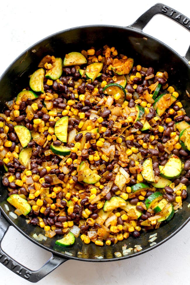 zucchini and corn enchilada filling in skillet 