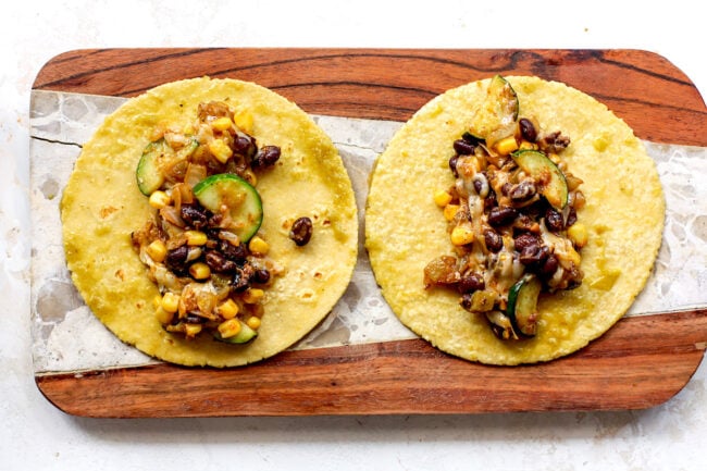 corn and zucchini enchilada filling on corn tortillas