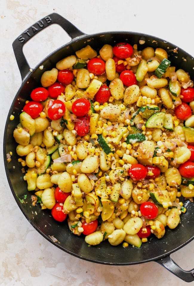 Butter Parmesan Gnocchi with squash, corn, and tomatoes in skillet