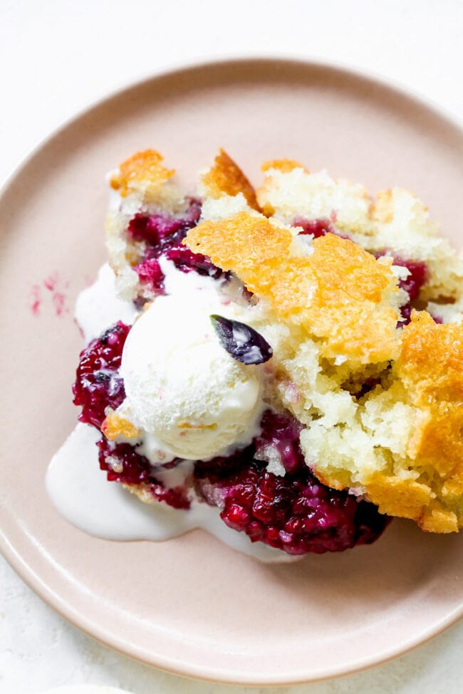 blackberry cobbler on plate with vanilla ice cream