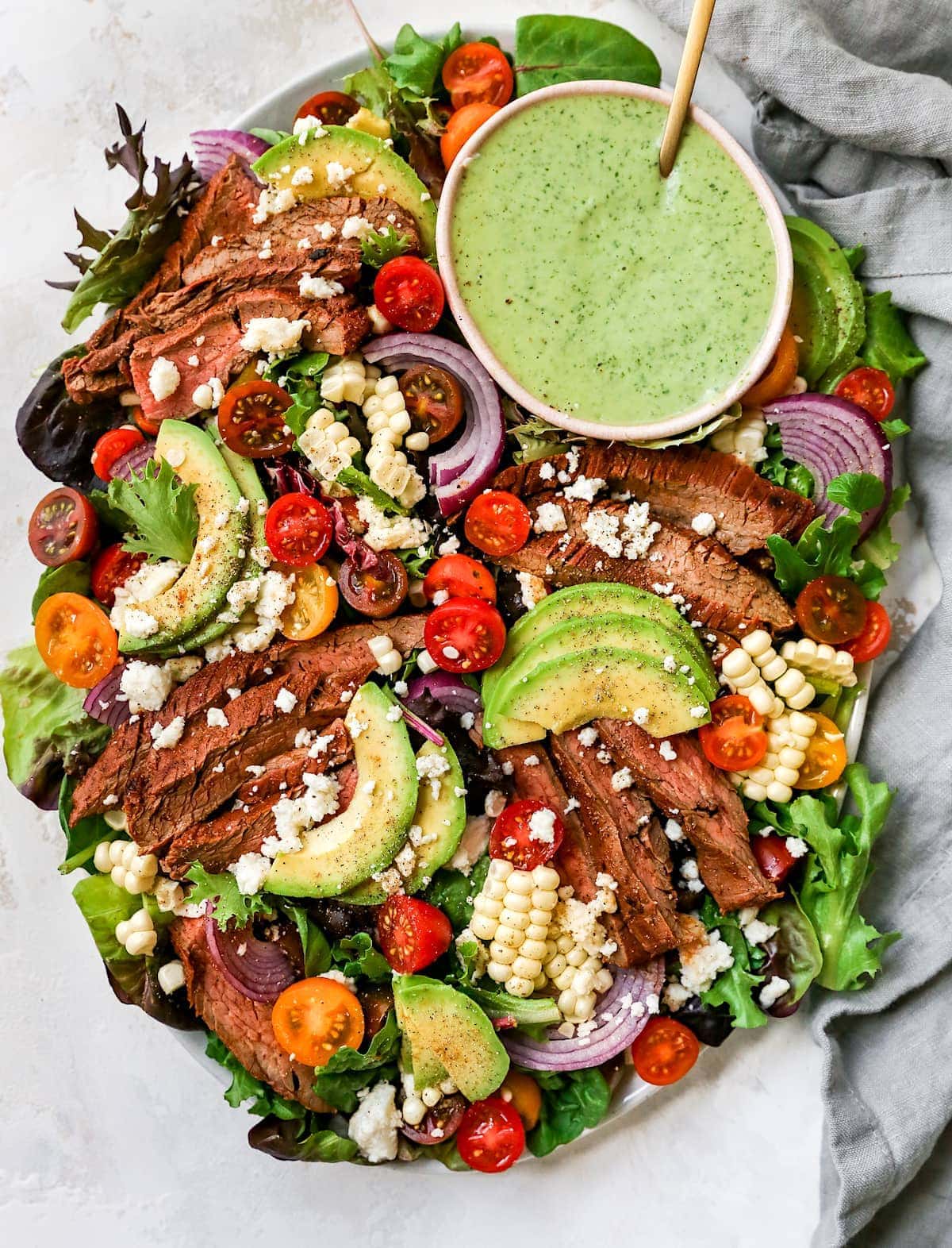 steak salad on platter with creamy cilantro lime dressing.