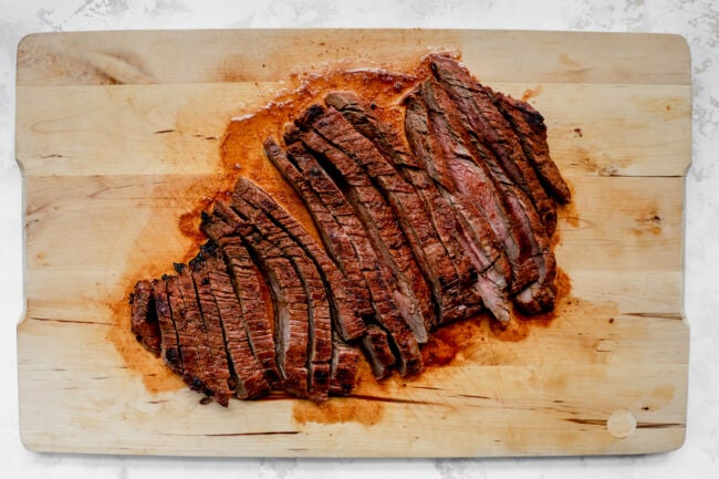 steak sliced on cutting board for steak salad