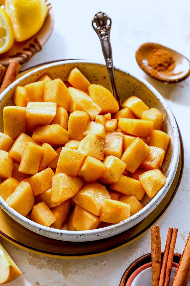 cinnamon apples in bowl with spoon