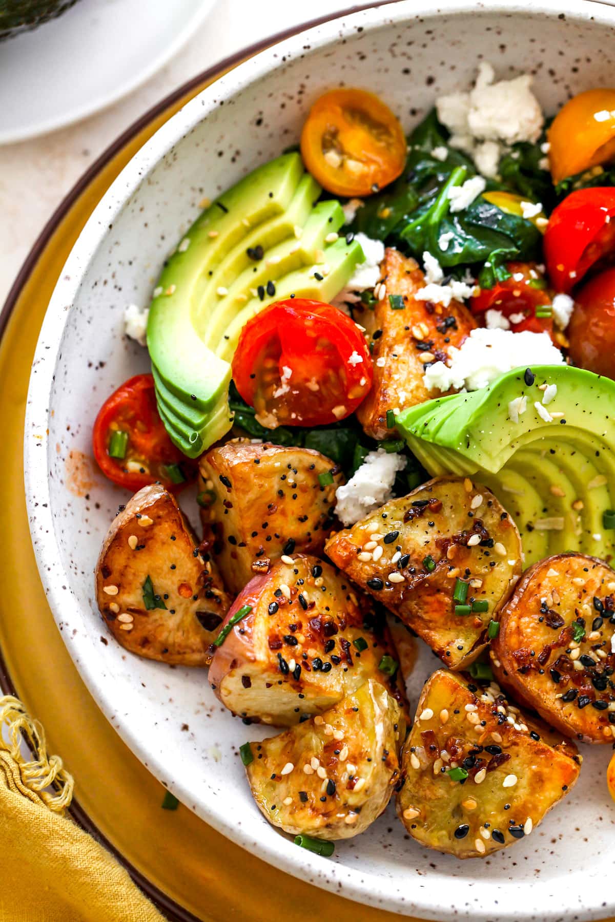 close up of savory breakfast bowl with roasted potatoes in bowl. 