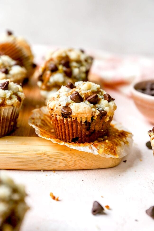 pumpkin chocolate chip muffins with streusel on wood board. 