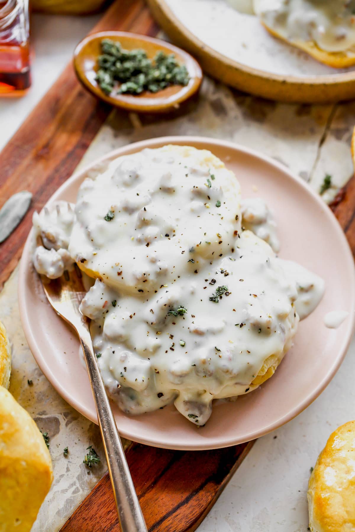 biscuits and gravy on on plate with fork. 
