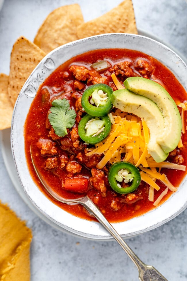 no bean chili in bowl with toppings