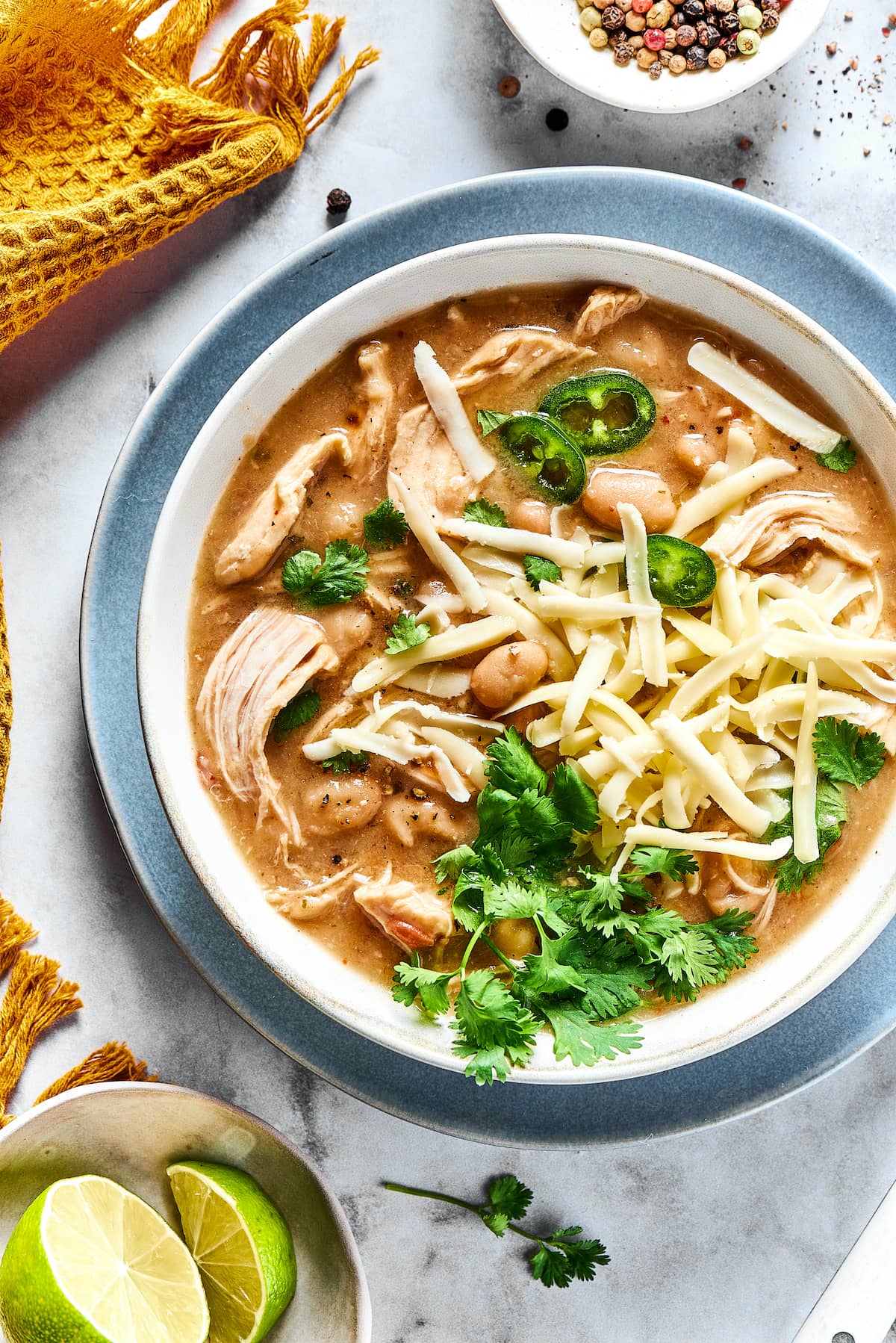 Overhead view of a bowl of white chicken chili garnished with fresh cilantro.