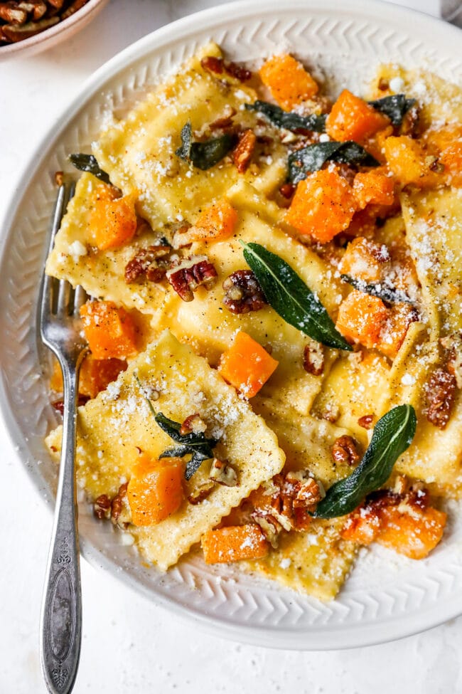 brown butter ravioli with butternut squash on plate with fork