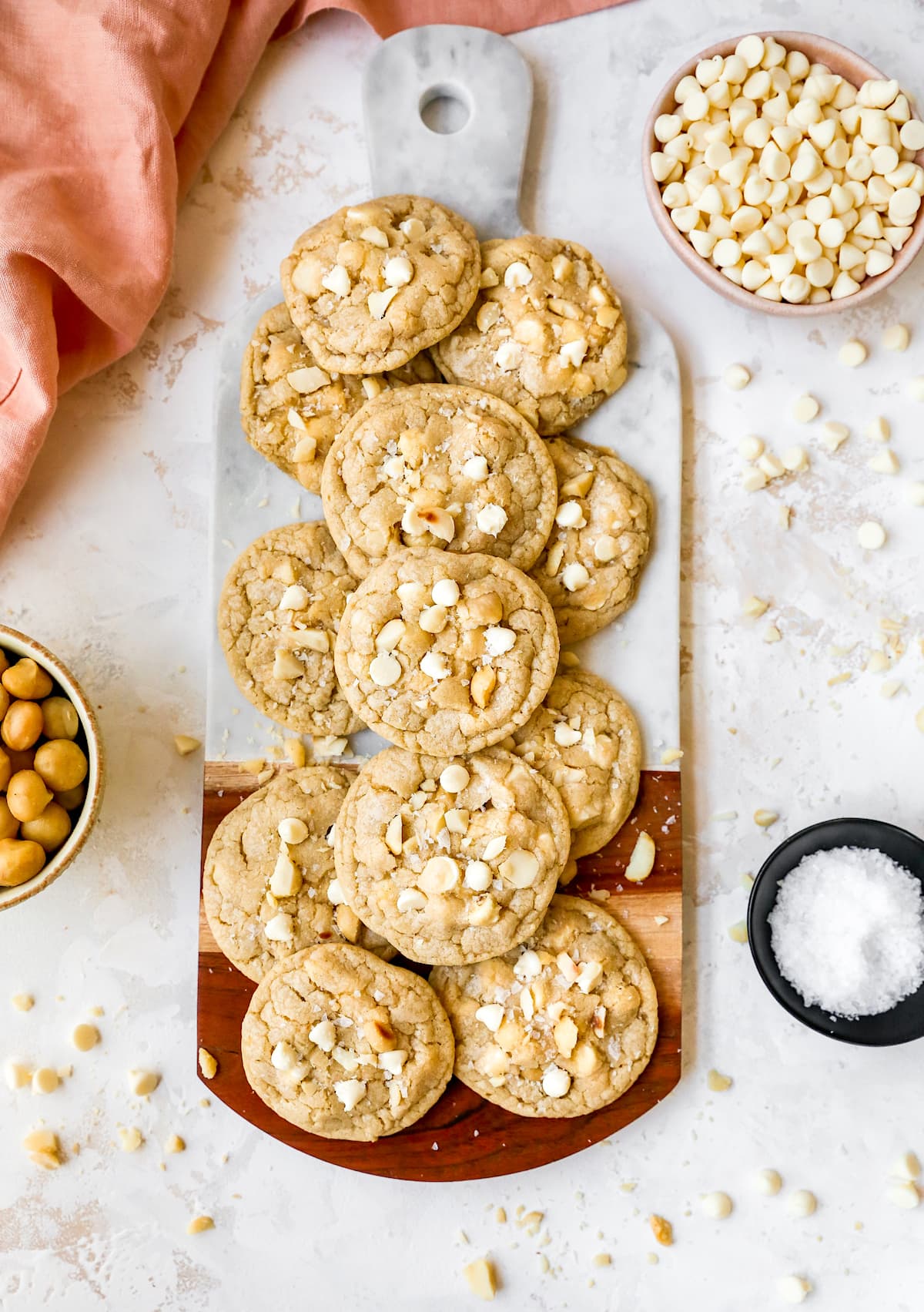 white chocolate macadamia nut cookies on marble wood board. 