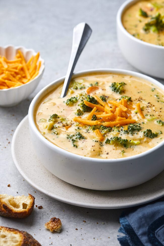 broccoli cheese soup in bowl with spoon