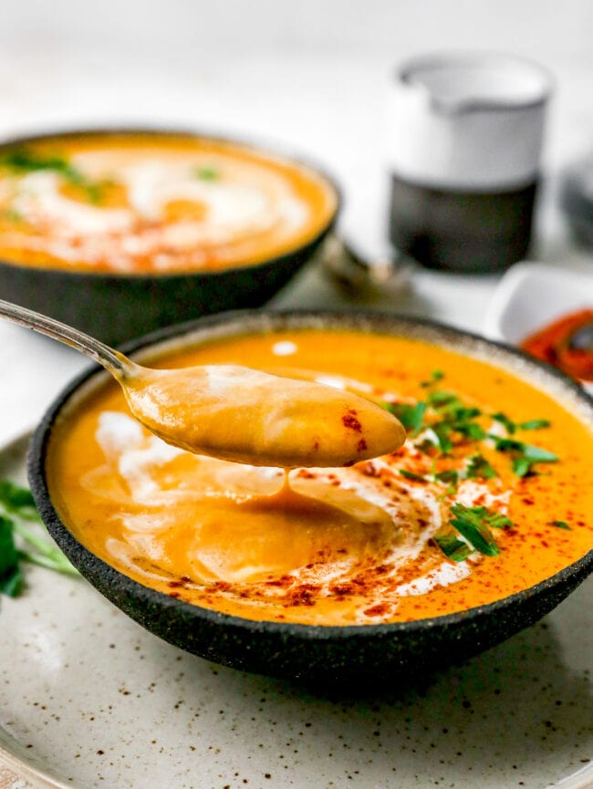 bowl of sweet potato soup with spoon