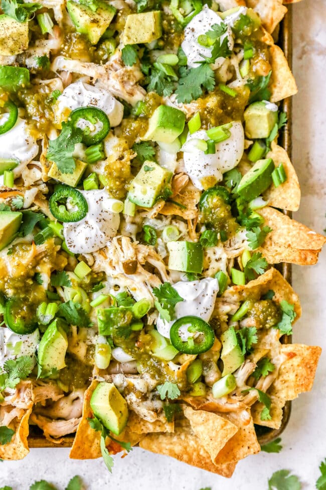 white chicken chili nachos on sheet pan