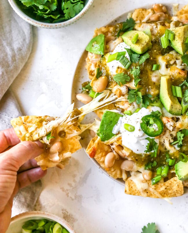 white chicken chili nachos with cheese and toppings