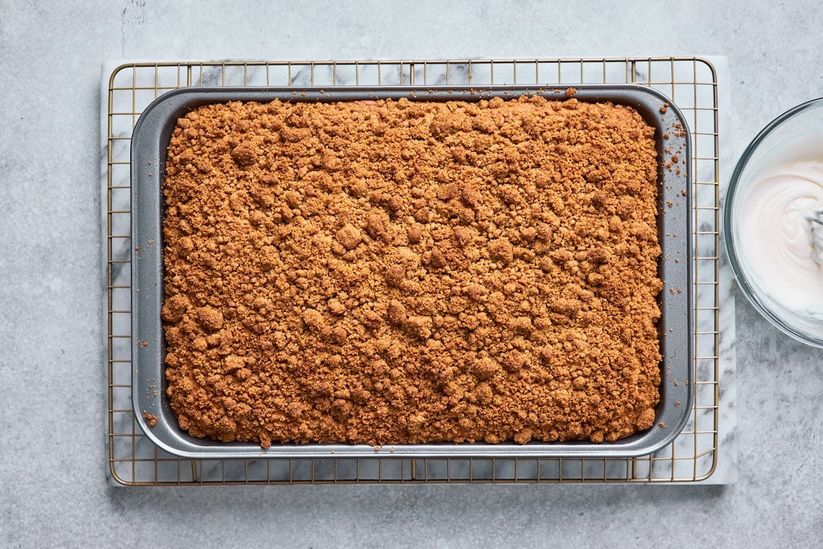 baked coffee cake in pan on cooling rack. 