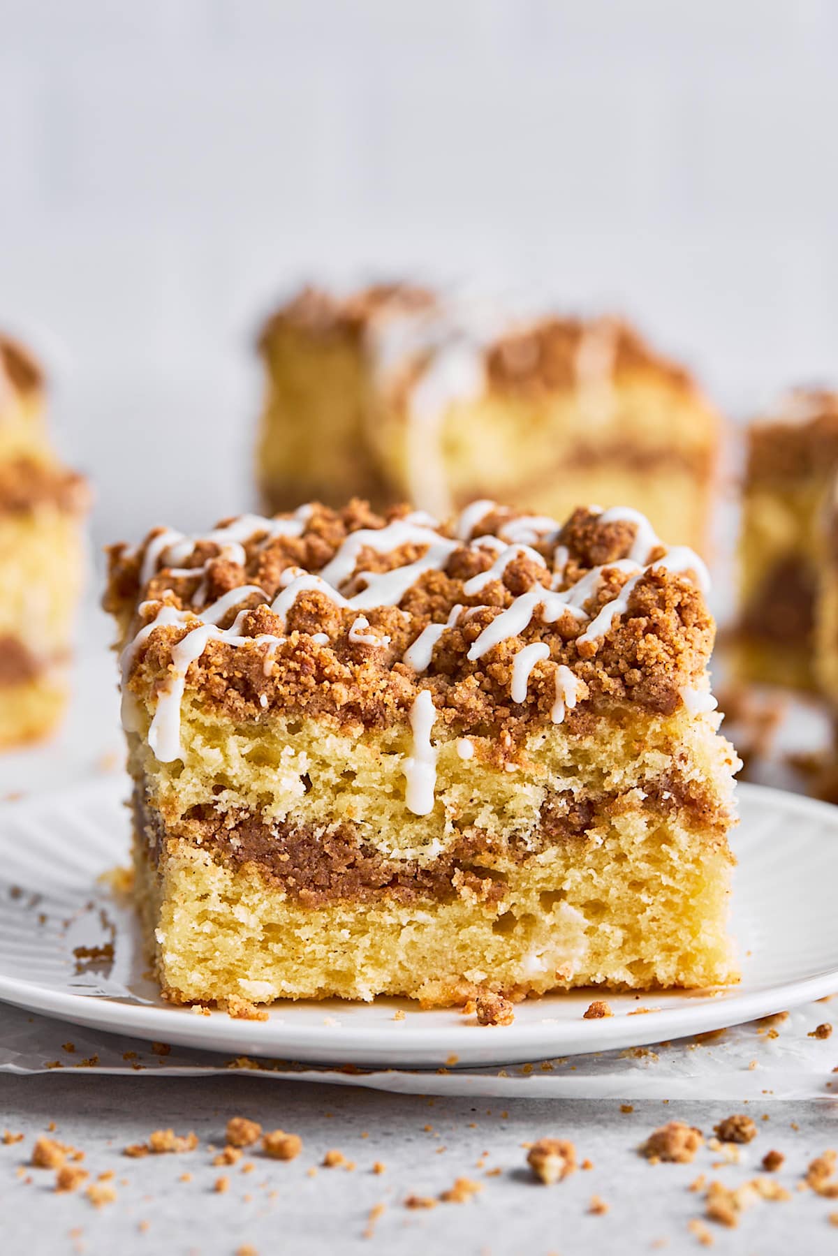 piece of coffee cake on plate with icing. 