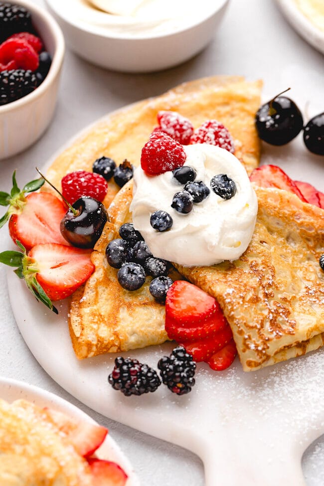 crepes with berries and whipped cream. 