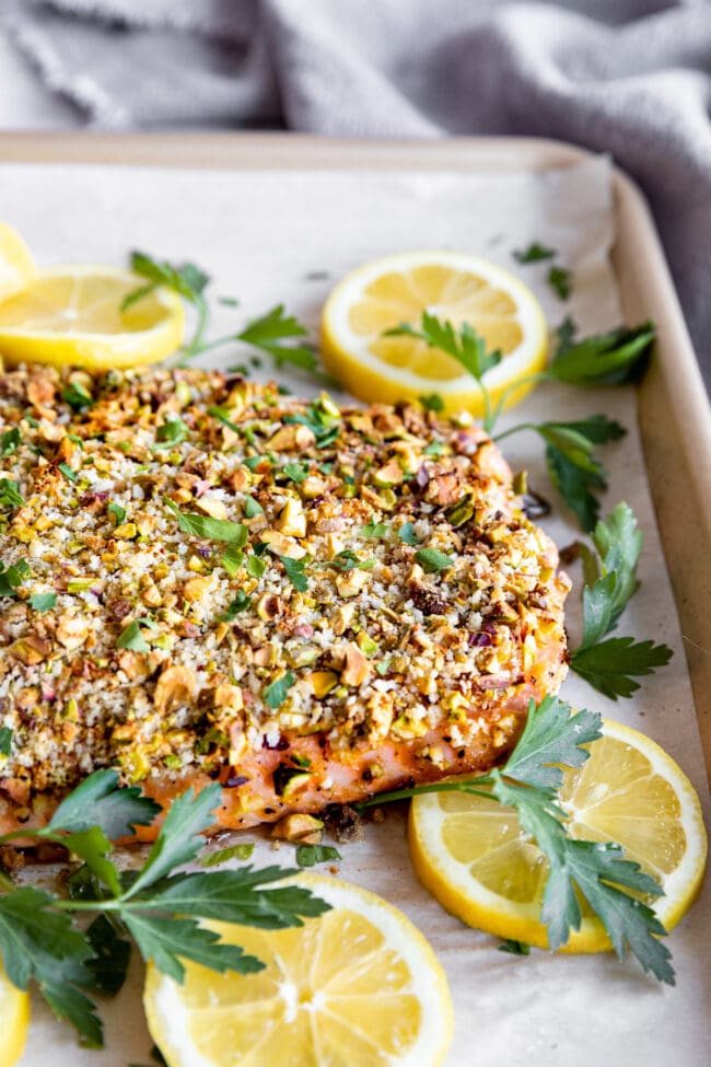 pistachio crusted salmon on baking sheet