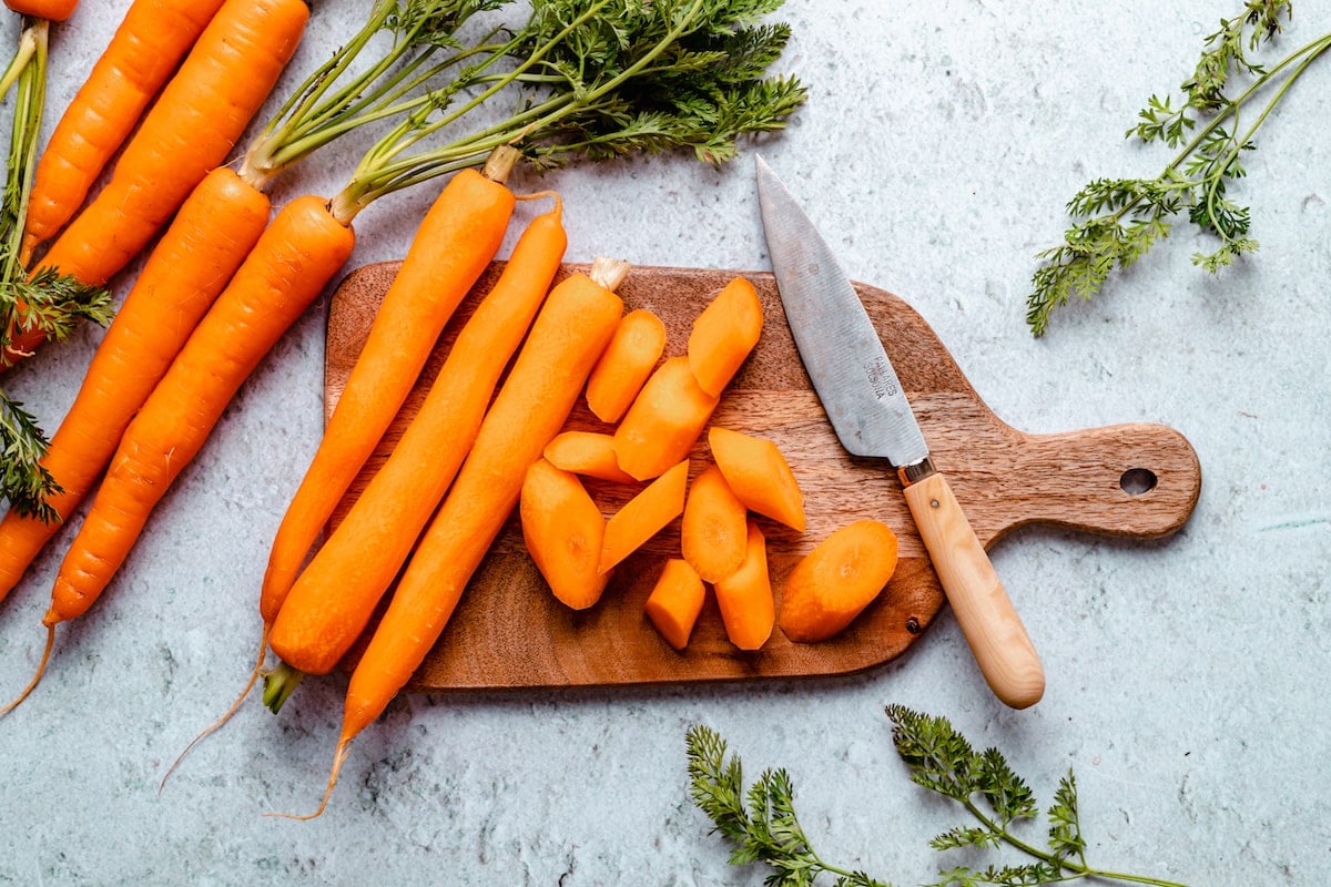 carrots on cutting board with knife.