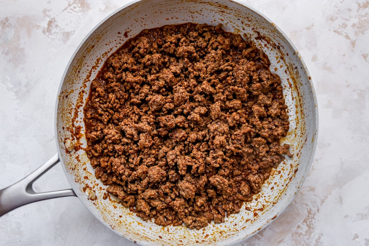 taco meat cooking in skillet. 