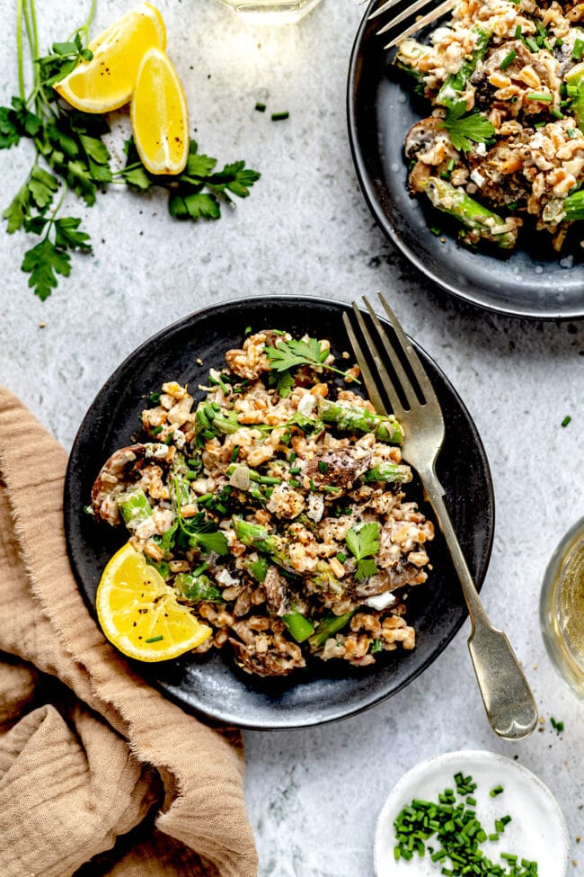 farro with mushrooms and asparagus on plate with fork